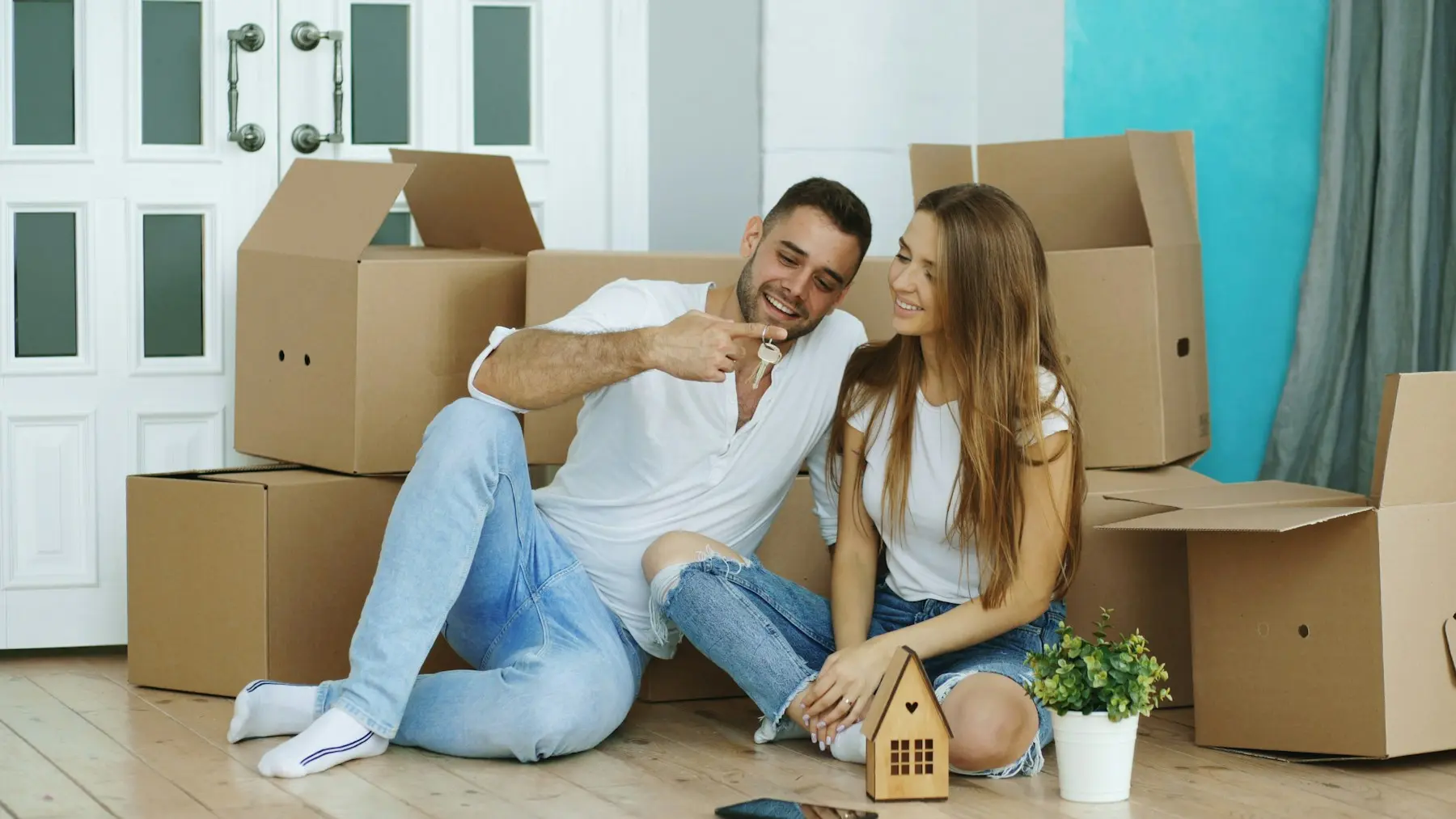 Couple relaxing together among moving boxes in their new home